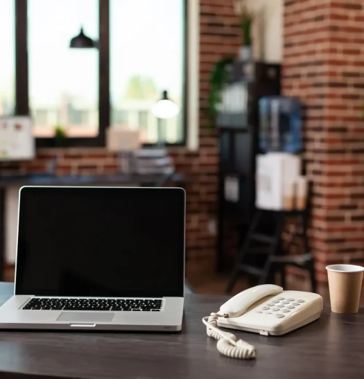 desk-with-laptop-and-telephone-in-empty-startup-pl-2026-03-19-01-50-08-utc